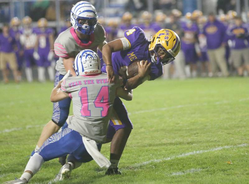 Mendota's Jayden Lesley runs with the ball as Princeton's Jack Oester and Owen Hartman bring him down on Friday, Oct. 10, 2025 at Bryant Field in Princeton.