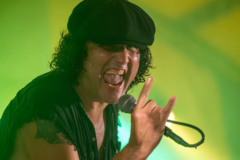 Bobby Lee Stamper of Thunderstruck sings into the microphone whilst making the "Rock and Roll" hand signal at the annual Cops for Cancer event on Friday, July 26, 2025, at Cerri Memorial Park in Cedar Point.