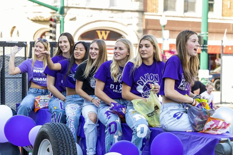 Members of the Dixon volleyball ride a float Friday, Oct. 3, 2025, during the homecoming parade.