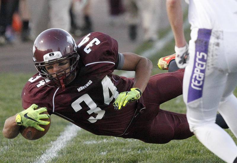 Marengo's Jarrell Jackson dives for a few extra yards against Plano during their Class 4A playoff game Friday in Marengo. Marengo won, 44-0.