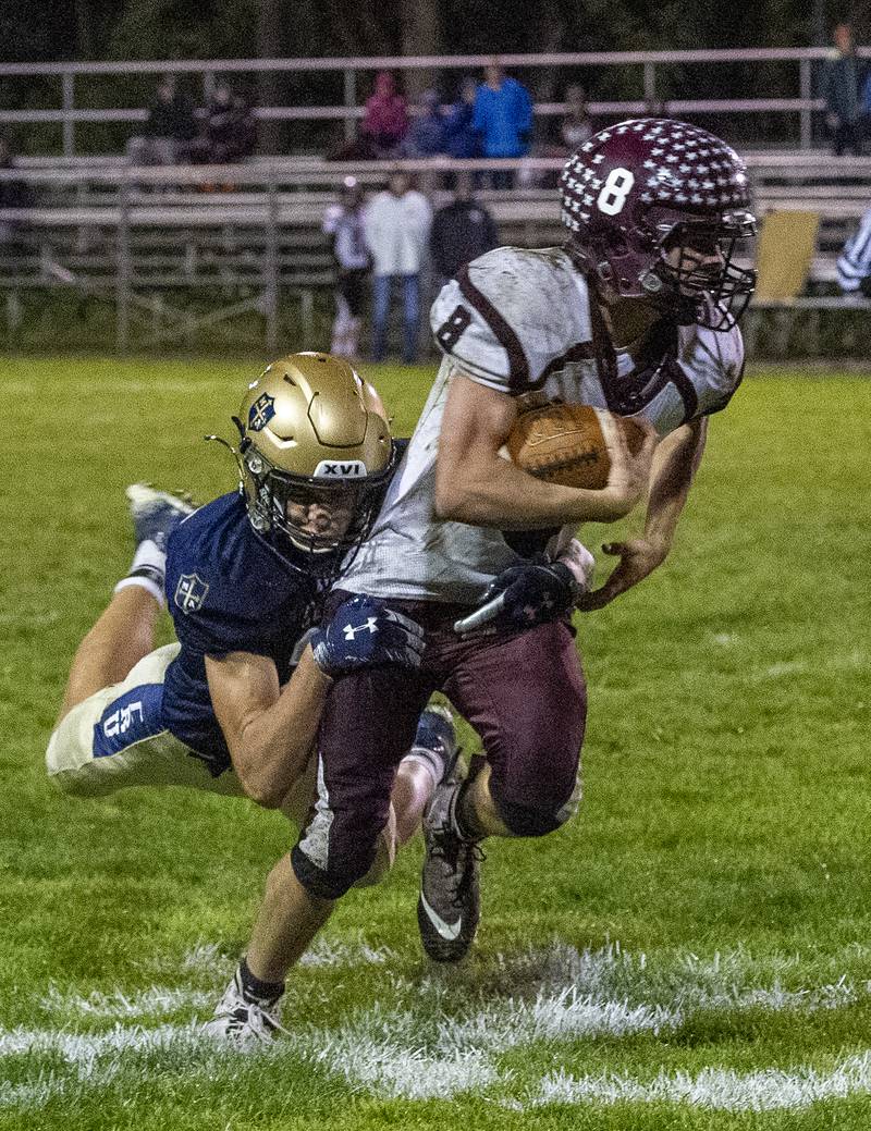 Marquette's Charlie Mullen makes the tackle on Princeville's Denver Hoerr in the second quarter of their 1A playoff game at Gould Stadium in Ottawa Friday.