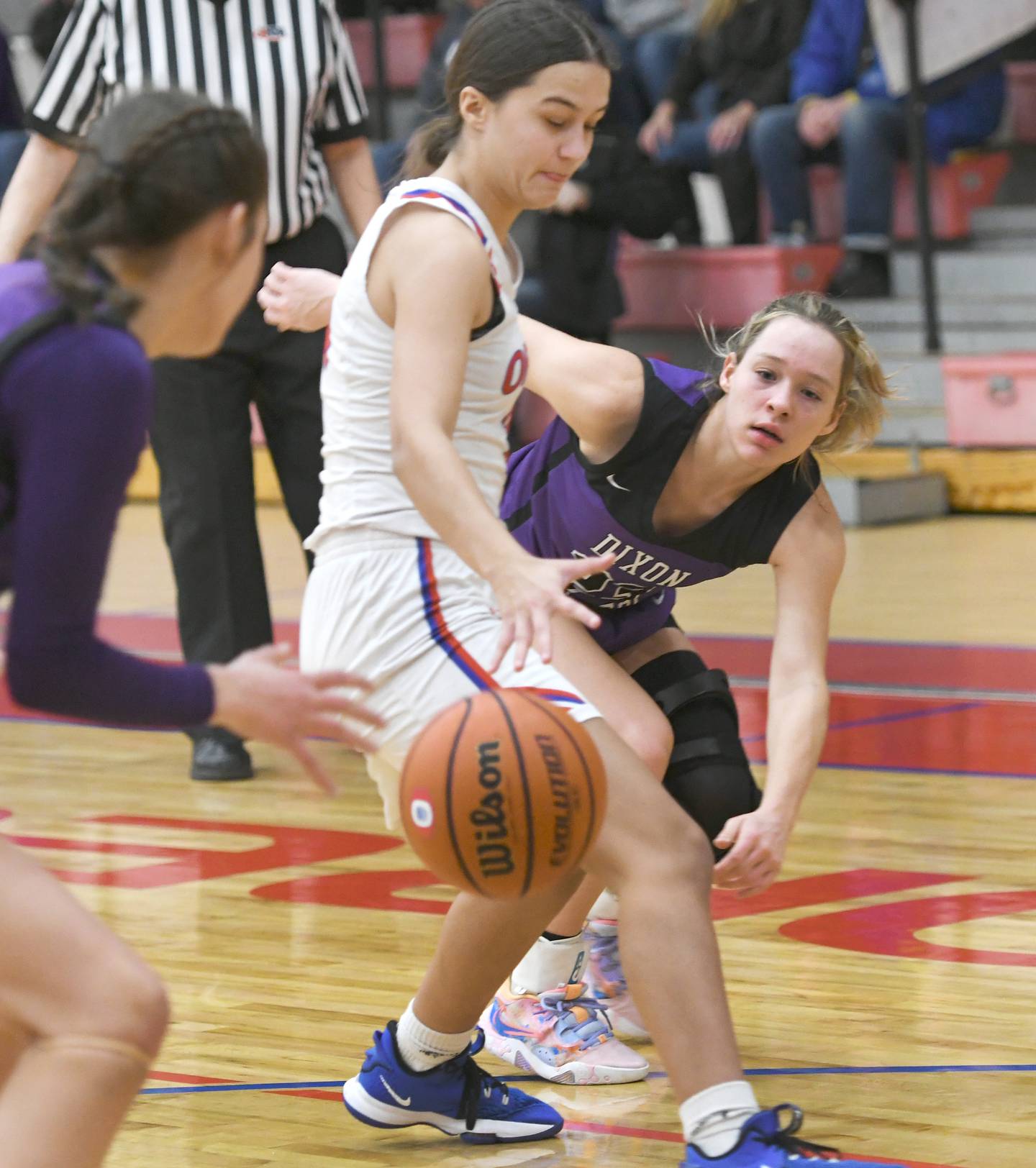 Dixon's Hannah Steinmeyer (23) makes a pass to teammate Harvest Day as Oregon's Sarah Eckhardt defends during Big Northern Conference action at the Blackhawk Center in Oregon on Saturday, Jan, 21.