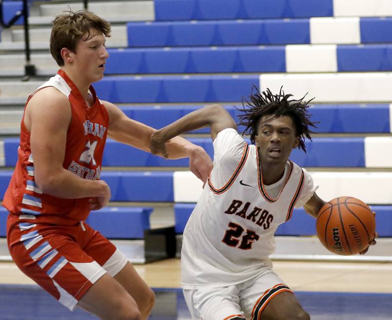 DeKalb's Darell Island drives the baseline against Marian Central's Christian Bentancur during a Central High School’s Dr. Martin Luther King, Jr., Boys Basketball Tournament game Friday, Jan. 13, 2023, at Central High School in Burlington.
