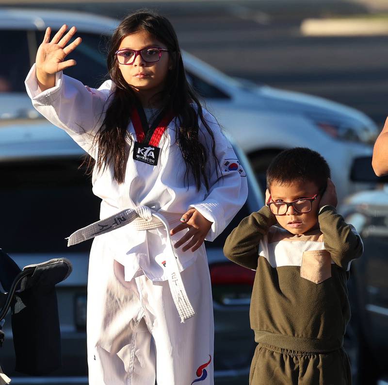 Parade goers are mixed on how to react as the DeKalb fire trucks blare their sirens while heading down West Dresser Road Wednesday, Oct. 2, 2024, during the DeKalb High School homecoming parade.