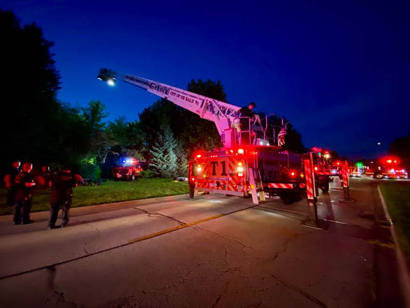 DeKalb firefighters are hoisted into the air on a ladder truck to help provide light to emergency divers undertaking a water rescue on Sunday, July 27, 2025, in the 600 block of Ridge Drive in DeKalb.