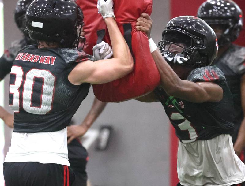 Northern Illinois’ Rickey Taylor Jr. (right) participates in a drill Wednesday, July 30, 2025, during their first practice in the Chessick Practice Center at NIU in DeKalb.