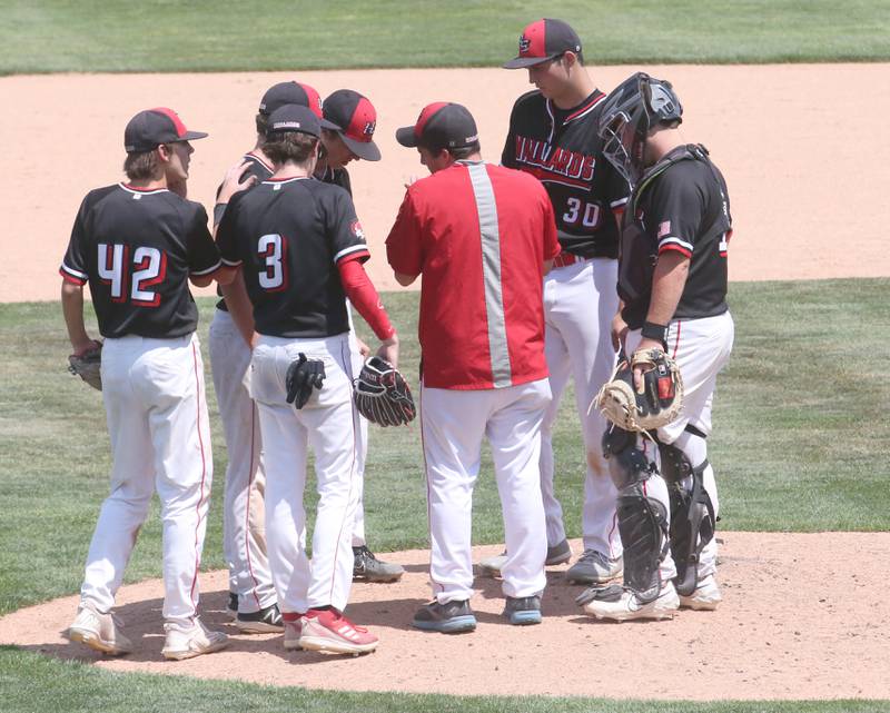 Henry-Senachwine head coach Max Kirbach talks to his team on the mound while facing Newman during the Class 1A State semifinal game on Friday, June 2, 2023 at Dozer Park in Peoria.