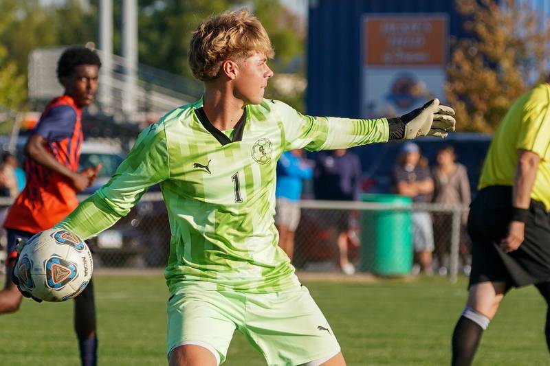 Oswego East's Jack Urbanowski (1) throws the ball in during a soccer match against Oswego at Oswego High School on Tuesday, Oct. 1, 2024.