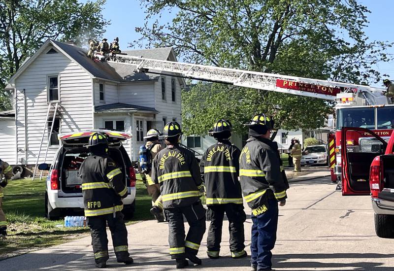 Firefighters work the scene of a house fire in the 800 block of North Mercer Street on Wednesday, April 22, 2026 in Princeton.