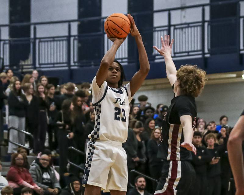 Oswego East's Mason Lockett IV (23) shoots a jump shot during their basketball game between Plainfield North at Oswego East Friday, Dec 5, 2025 in Oswego.