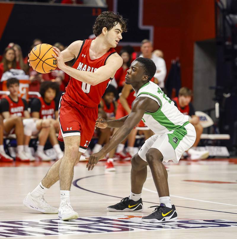 Marist's Adoni Vassilakis (0) tries to get around York’s Nathan Poku (21) during the IHSA Class 4A boys basketball state semifinal Friday, March 13, 2026 at the State Farm Center in Champaign.