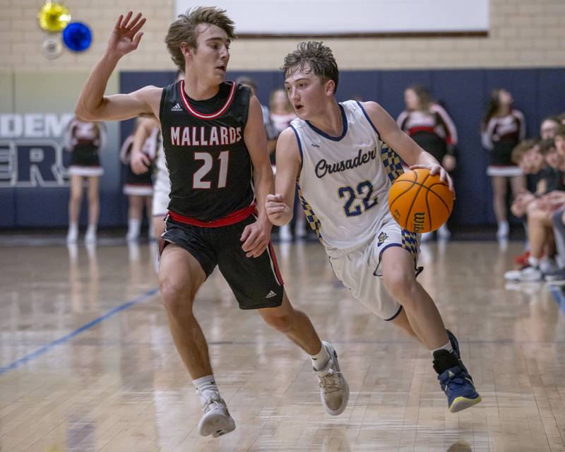 Griffin Dobberstein (right) of Marquette pushes down the court against the defense of Carson Rowe of Henry-Senachwine during the game on February 7, 2025 at Bader Gym.