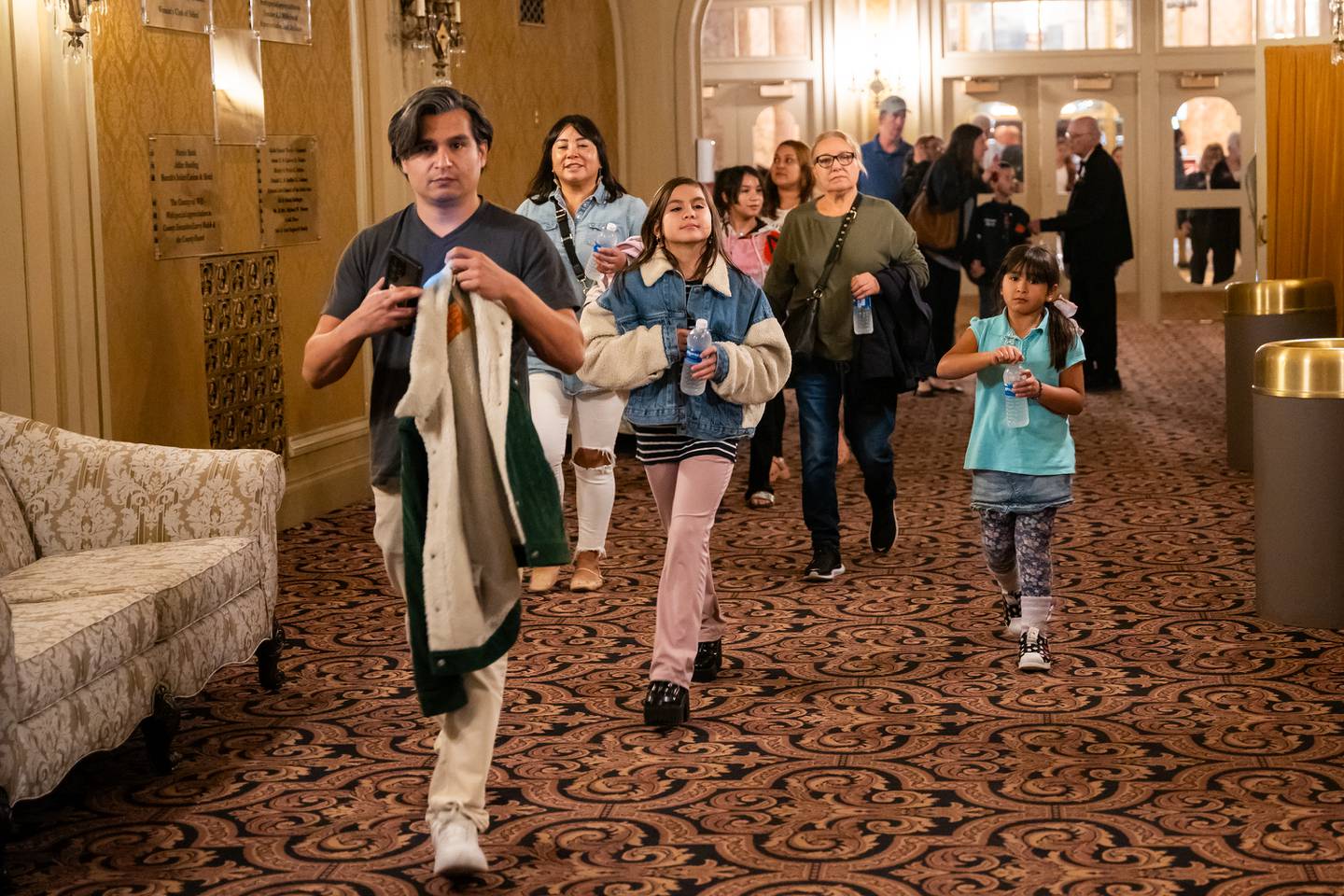 Concert attendees for the Vitamin String Quartet enter the lobby for the reopening of the Rialto Square Theatre in Joliet, Ill. on Tuesday Oct. 22, 2024