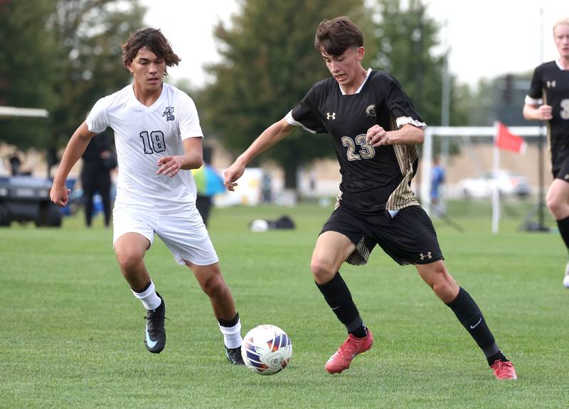 Kaneland's Dylan Pilz (left) tries to get the ball away from Sycamore's Leo Padilla during their game Monday, Oct. 6, 2025, at Sycamore High School.