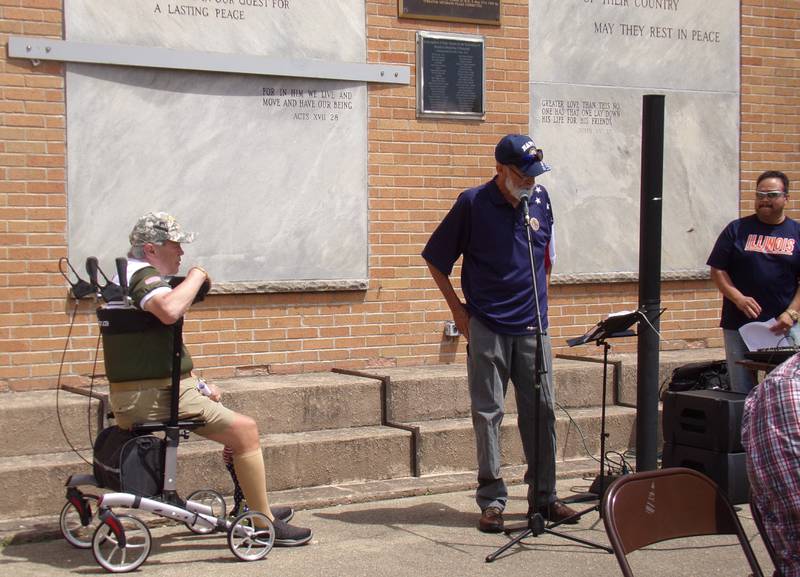 Dan Austin (at the microphone) sings "Arlington" by Trace Adkins on Monday, May 27, 2024, during the Memorial Day ceremony at Veterans Memorial Plaza in Streator's City Park.