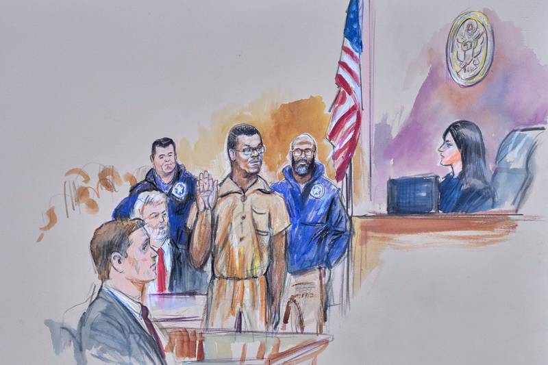 This courtroom sketch depicts Brian Cole Jr., 30, of Woodbridge, Va., the man accused of planting a pair of pipe bombs outside the headquarters of the Republican and Democratic national parties on  Jan. 5, 2021, in Washington, being sworn in, Friday, Dec. 5, 2025 before U.S. Magistrate Moxila Upadhyaya, at Federal Court in Washington, as U.S. Attorney Charles Jones, seated left, and Defense Attorney John Shoreman, seated center, look on. (Dana Verkouteren via AP)