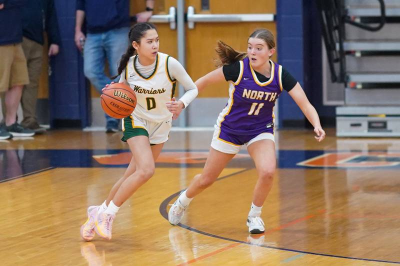 Waubonsie Valley's Maya Pereda (0) plays the ball on the wing against Downers Grove North's Abby Gross (11) during a Oswego semifinal sectional 4A basketball game at Oswego High School on Tuesday, Feb 20, 2024.