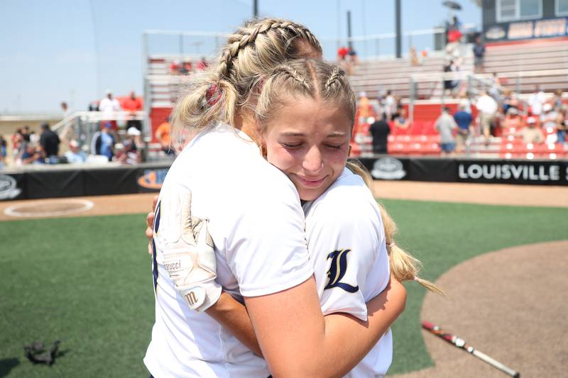 An emotional Frankie Rita, catcher for Lemont, hugs her pitcher Sage Mardjetko after their 1-0 win against Antioch in the Class 3A state championship game on Saturday, June 10, 2023 in Peoria.