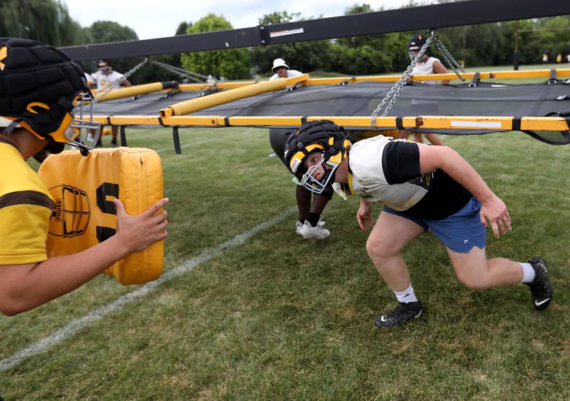 Jacobs’ Lucas Retzler runs throw a blocking drill during football practice on Tuesday, August 15, 2025, at Jacobs High School in Algonquin.
