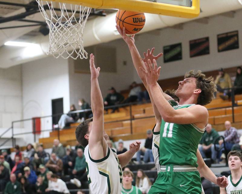 Dwight's Joey Starks drives to the hoop to score a bucket over St. Bede's Carson Riva during the Tri-County Conference Tournament on Tuesday, Jan. 27, 2026 at Putnam County High School.