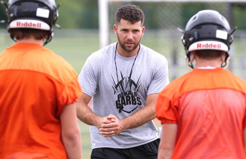 DeKalb head coach Derek Schneeman talks to his players Monday, Aug. 8, 2022, at the school during their first practice ahead of the upcoming season.