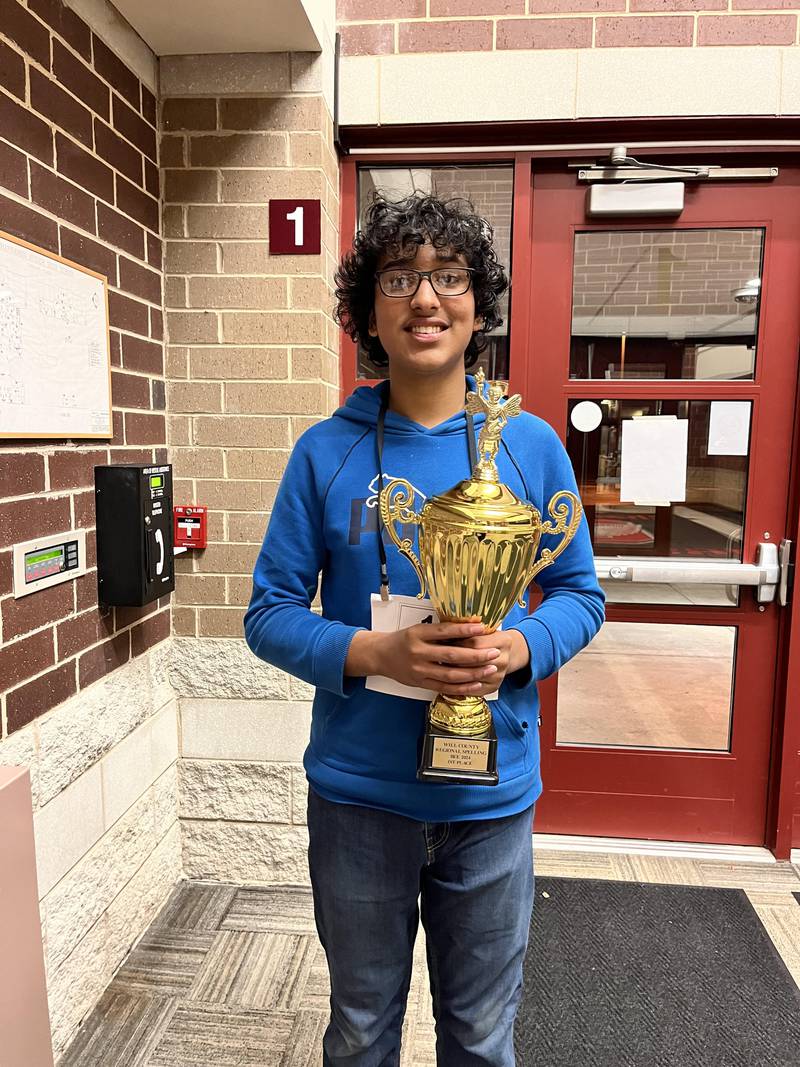 Channahon Junior High eighth grader Ribhu Chaher with his Will County Regional Spelling Bee trophy.