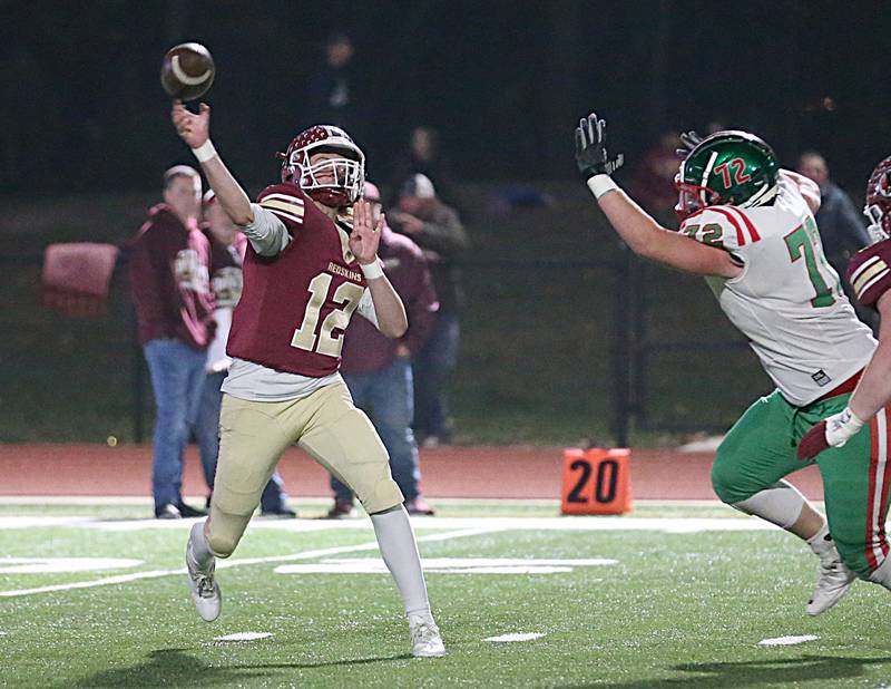Morris's Carter Button (12) throws a pass down the field as L-P's Nikolas Belski (72) approaches during the Class 5A round one football game on Friday, Oct. 28, 2022 in Morris.