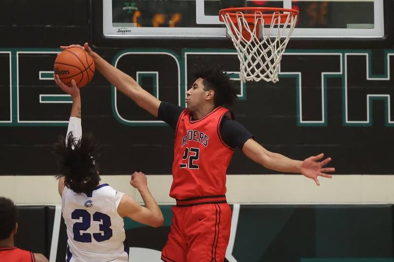 Bolingbrook’s JT Pettigrew blocks a shot by St. Francis’ Dylan Ston in the Jack Tosh 2023 Holiday Classic on Wednesday, Dec.27th, 2023 in York.