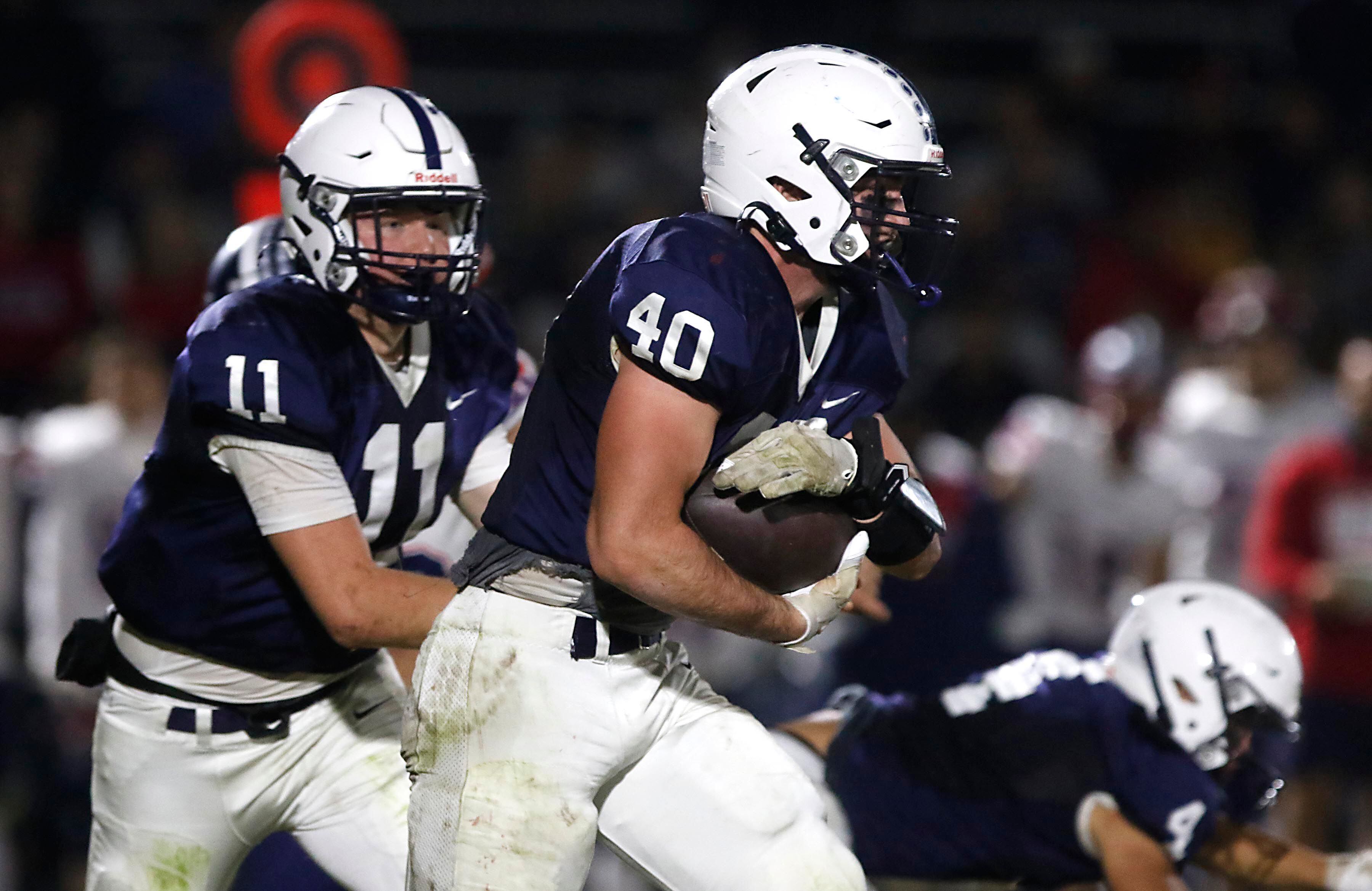 Cary-Grove's Logan Abrams runs with the football during an IHSA Class 5A quarterfinal playoff football game against Belvidere North on Friday, November 14, 2025, at Cary-Grove High School, in Cary.