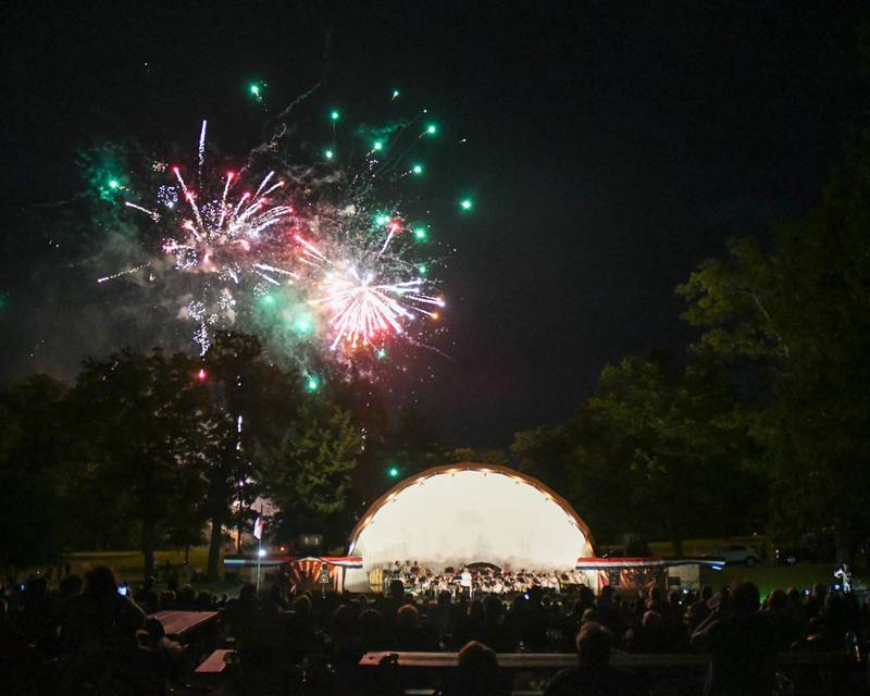 Fireworks explode during the annual Independence Day show hosted by the DeKalb Park District as the DeKalb Municipal Band performs Monday July 4, 2022 in DeKalb.