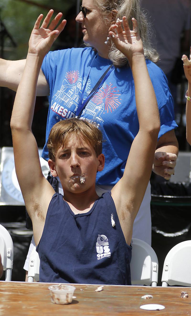 Max Baker, 14, raises his hands as he wins the eats ice cream eating contest during Lakeside Festival on Friday, July 5, 2024, at the Dole.