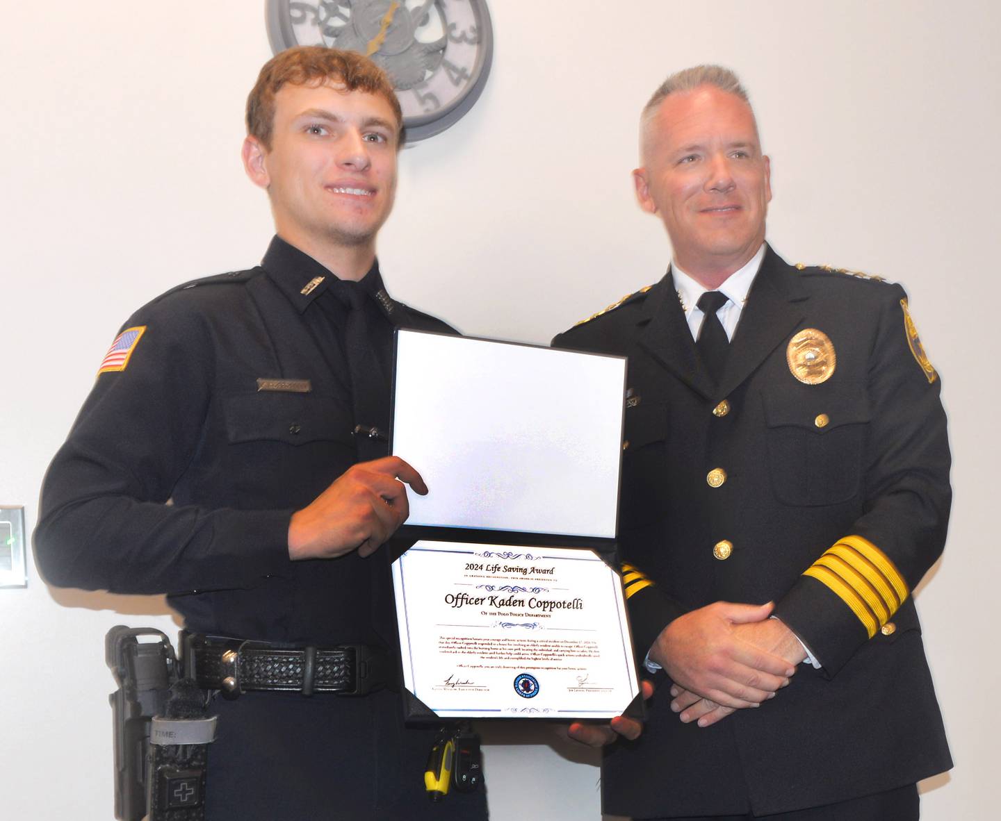 Polo Police Officer Kaden Coppotelli (left) receives the Illinois Association of Chiefs of Police Lifesaving Award from Moline Police Chief Darren Gault on Monday, July 7, 2025.