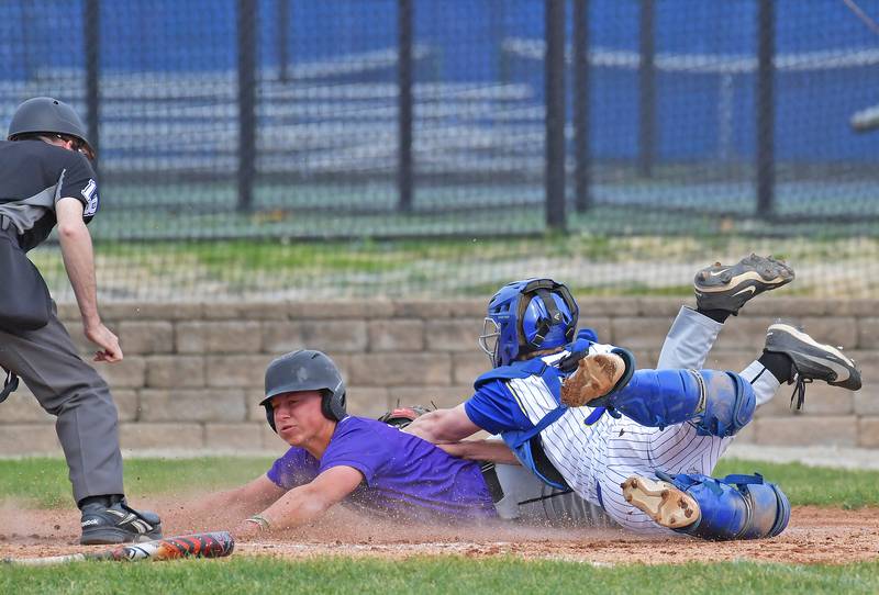 Downers Grove North’s Rhys Dominow is out at home plate after a tag by Lyons Township catcher Justin Heydorn during a game on May 18, 2026 at Lyons Township High School in LaGrange.