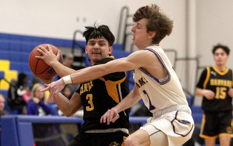 Harvard’s  Joseph Vazquez, left, battles Johnsburg’s Riley Johnson in varsity boys basketball at Johnsburg Saturday.
