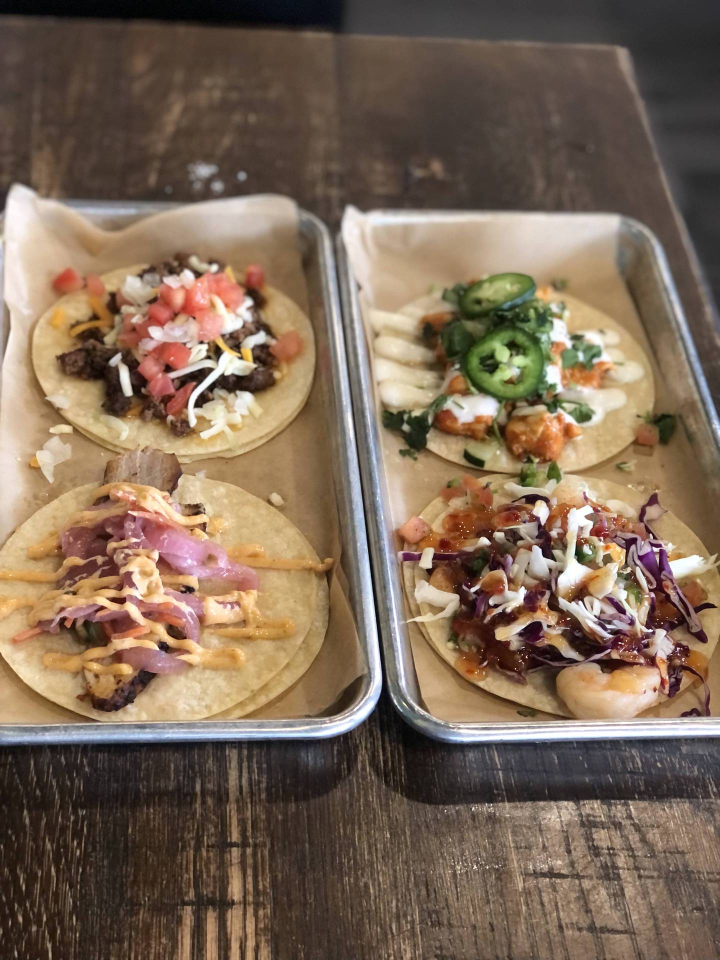 We ordered a selection of tacos, including top left to right, The Gringo,  made with seasoned ground beef, onion, tomato, lettuce and shredded cheese; the Tikka Taco, made with chicken tikka masala, fresh cucumber, jalapeno cilantro; lower left to right, BBQ pulled pork, made with seasoned pork, pickled veggies, jalapeno, sriracha aioli; and spicy shrimp with pico de gallo.