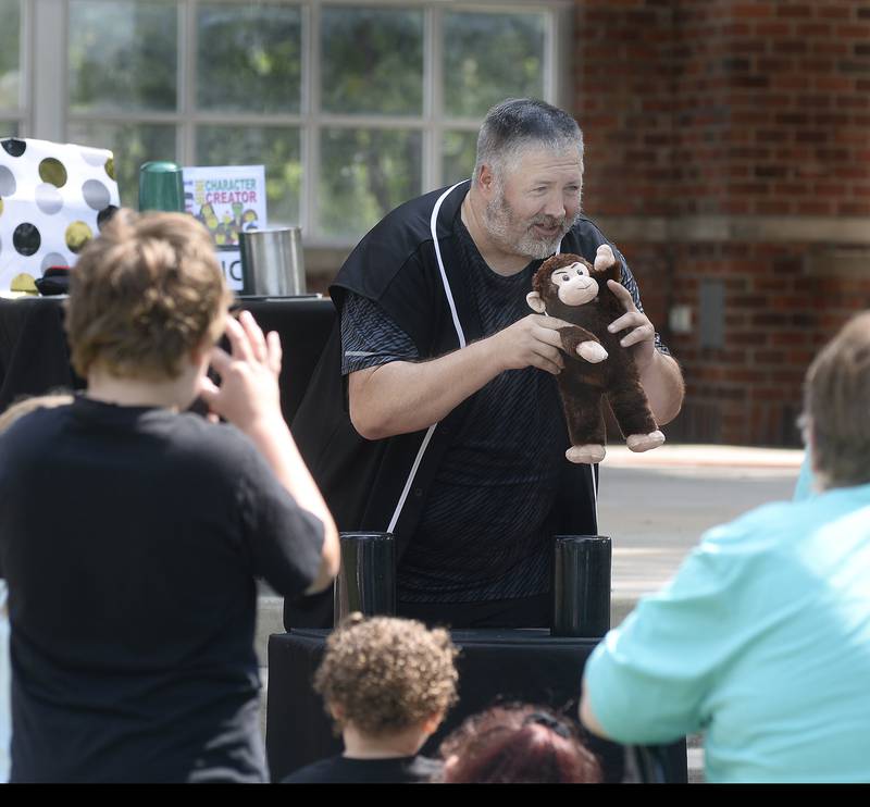 Keeping his audience entertained, Mark Nutzy Padgett, a local magician, uses a stuffed monkey as part of his act Tuesday, Aug. 8, 2023, during Unlimited Fun Day at City Park in Streator. The event was sponsored by Streator Unlimited.