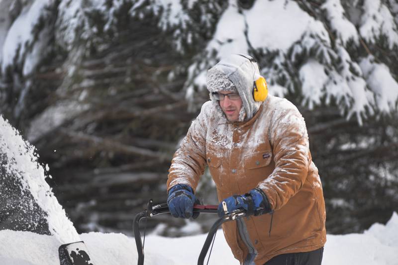 Steven Garbielson of Mt. Morris blows snow from his driveway on Saturday, Jan. 13, 2024. Friday's winter storm dumped 10-12 inches of snow on the village.