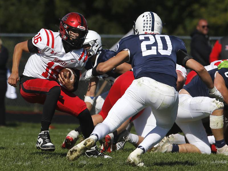 Huntley's Braylon Bower runs with the ball as Cary-Grove's Connor Anderson tries to fill the running lane during a Fox Valley Conference football game on Saturday, Oct. 7, 2023, at Cary-Grove High School.