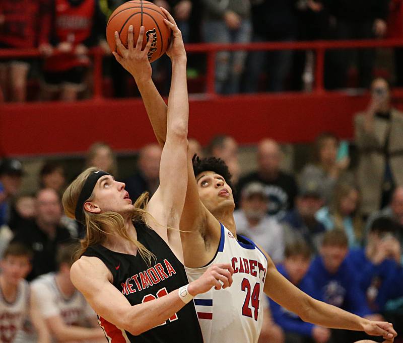 Metamora's Ethan Kizer wins the opening jump over Marmion's Travon Roots during the Class 3A Super-Sectional on Monday, March 6, 2023 at Ottawa High School.
