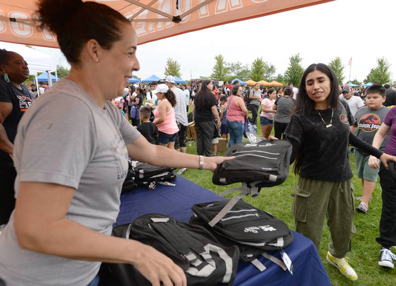 Clinical Coordinator for the Nurcing Program at Morton College, Geana Chapp provides backpacks during the District 99 Back to School Fair held at the Cicero Community Park Sunday Aug 13, 2023.