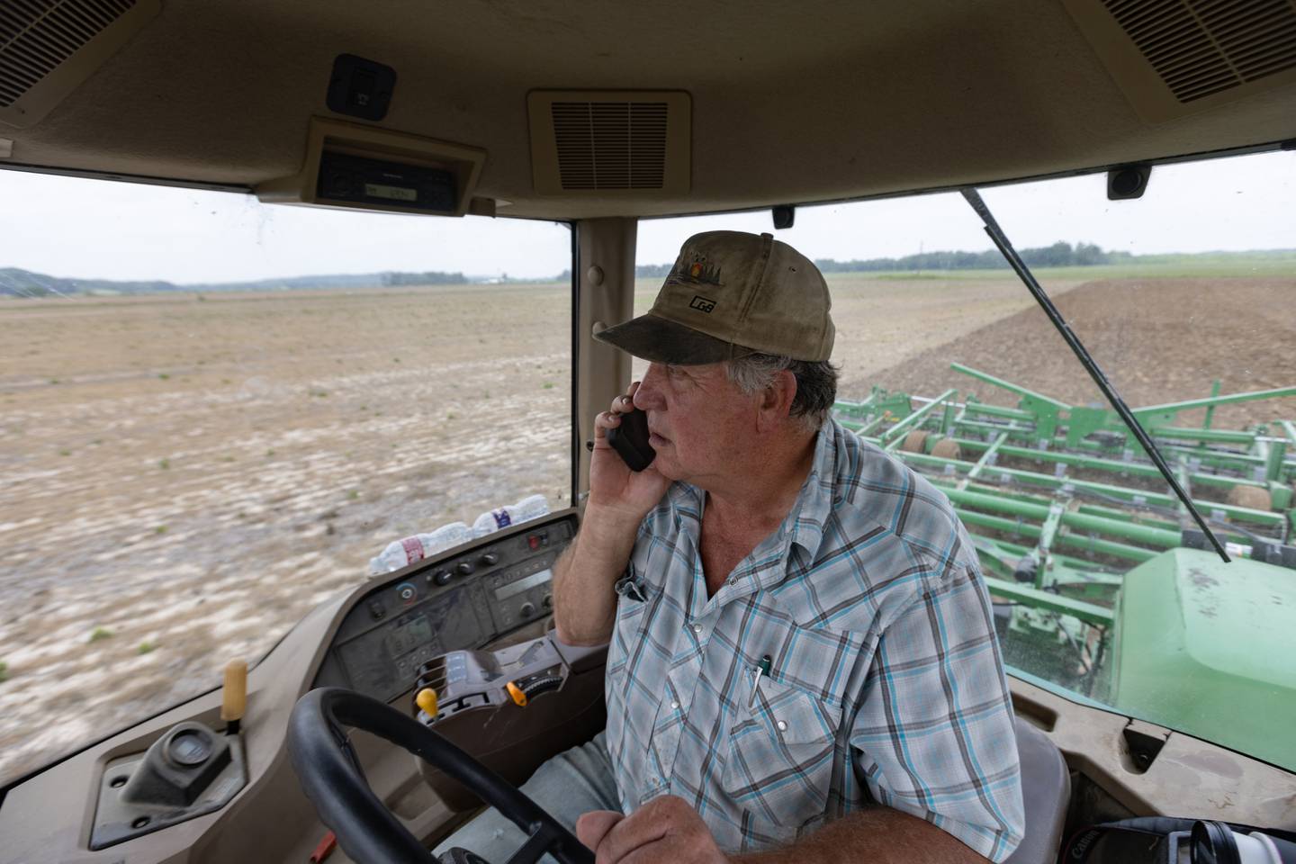 Steve Williams takes a call from Brandy Renshaw while he plants soybeans on his farm.