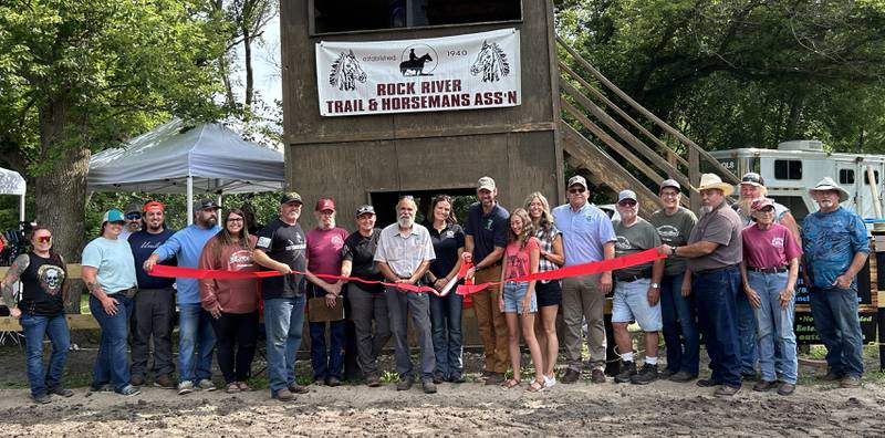 Franklin Creek State Park Site Superintendent Matt Hoogerwerf cuts the red ribbon as he poses with other dignitaries and members of the Rock River Trail & Horseman Association during the Grand Opening Show of the new Franklin Creek Arena on Saturday, July 20, 2024. The newly refurbished horse arena is located in Franklin Creek Natural Area, just north of Franklin Grove. It was completed through a cooperative effort between state park staff, volunteers from the RRTHA and donations from area businesses.