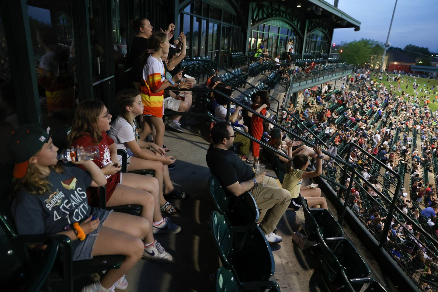 Fans from one of the suites celebrate a Joliet Slammers home run against the Ottawa Titans at the home opener. Friday, May 13, 2022, in Joliet.