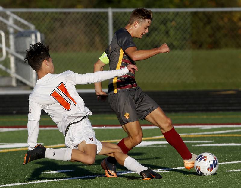 Richmond-Burton's Maddox Meyer passes the ball to his teammate Richmond-Burton's Dalton Youngs as he is defended by Winnebago's Wyatt Webb during the IHSA Class 1A Richmond-Burton Regional Final soccer match Tuesday, Oct. 17, 2023, at Richmond-Burton High School in Richmond.  Youngs scored a goal on the play.