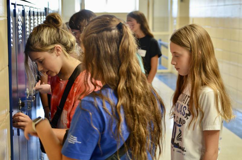 A group of incoming Herrick Middle School students get accustomed to the combination locks on the school lockers during Herrick's Sneak Preview event.