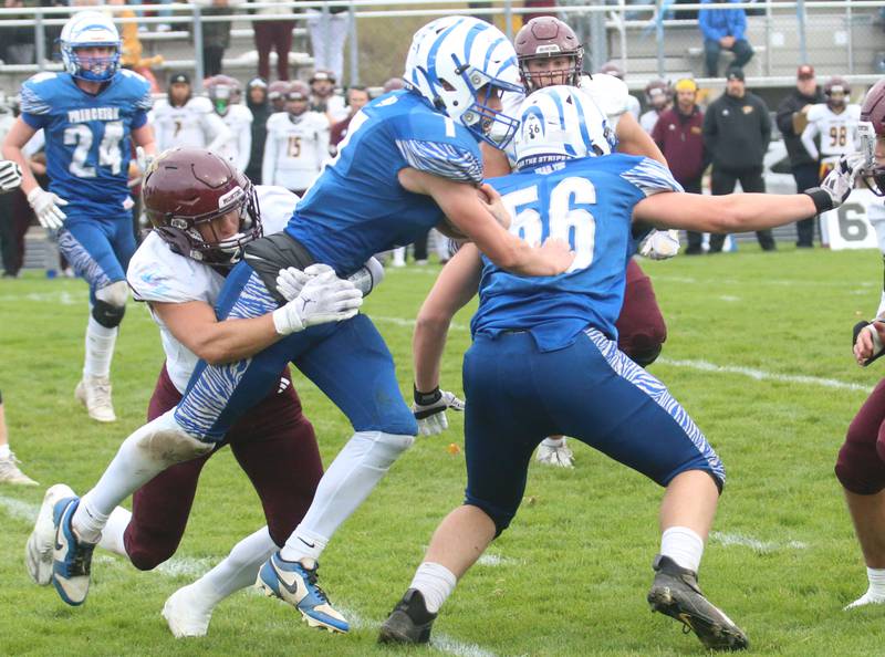 Princeton's Gavin Lanham fights for extra yards while being taken down by Montini Catholic's Nick Irion during the Class 3A quarterfinal game on Saturday, Nov. 16, 2024 at Bryant Field in Princeton.