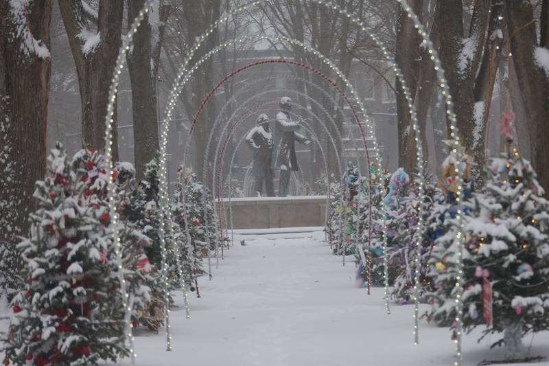 An arch of lights and Christmas trees line Washington Park near the Lincoln and Dougles statues on Saturday, Nov. 29, 2025 downtown Ottawa.