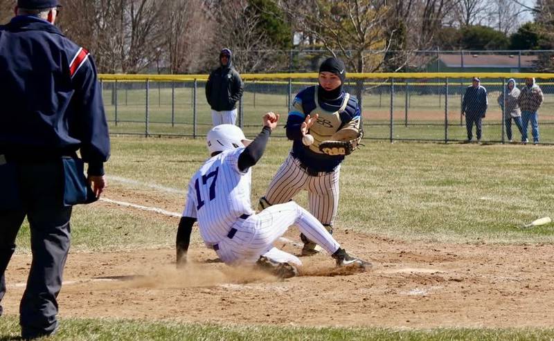 Rochelle's Braxton Bruns slides into home plate with a run during the Hubs' game with Ottawa Marquette.