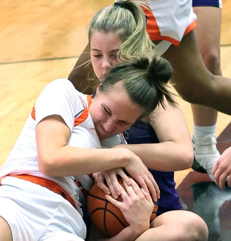 DeKalb's Kailey Porter fights a Rochelle player for a loose ball during their game Monday, Nov. 28, 2022, at DeKalb High School.
