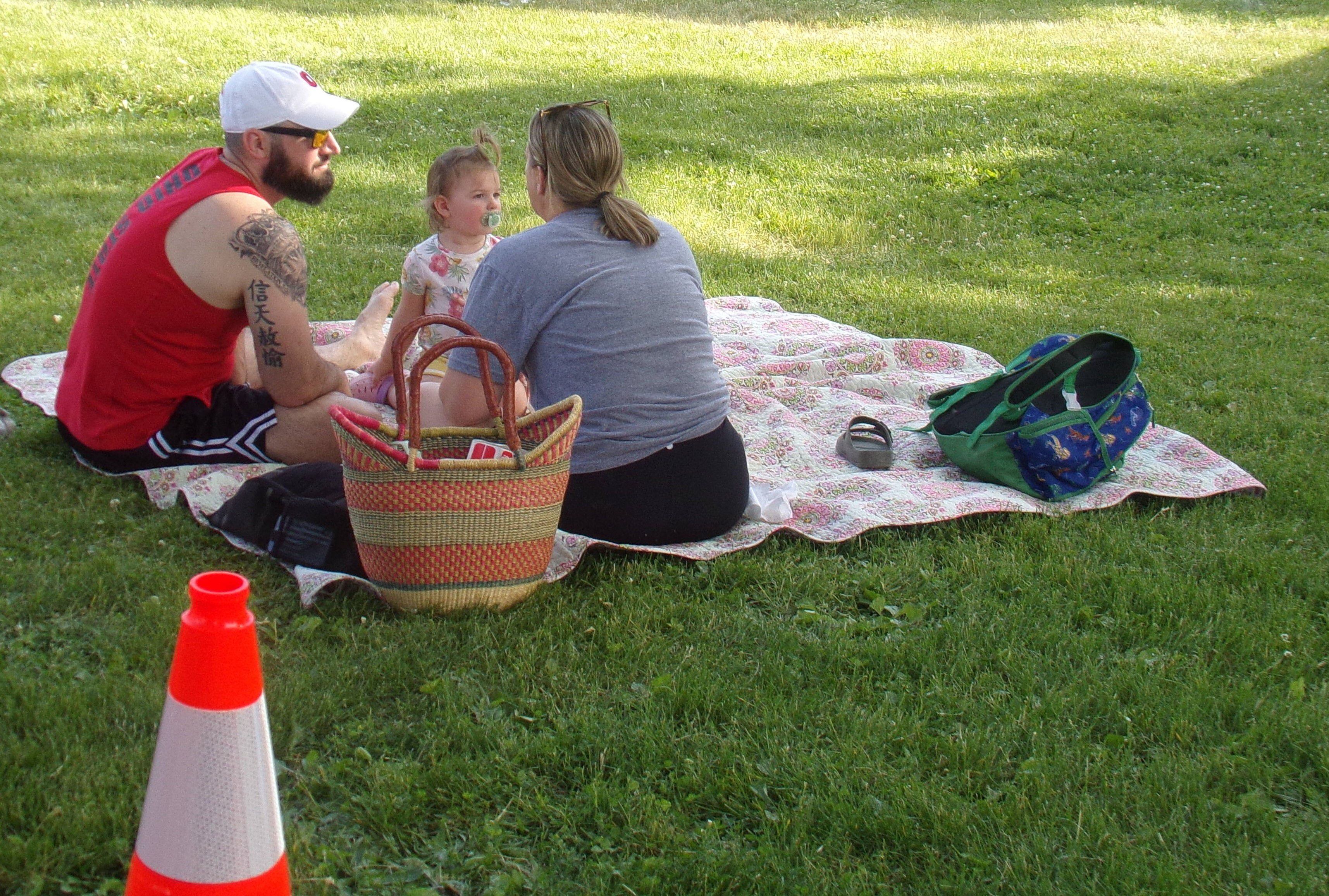 A family enjoys a picnic Sunday, May 28, 2023, during the Music and Art Festival at Pulaski Park in La Salle.
